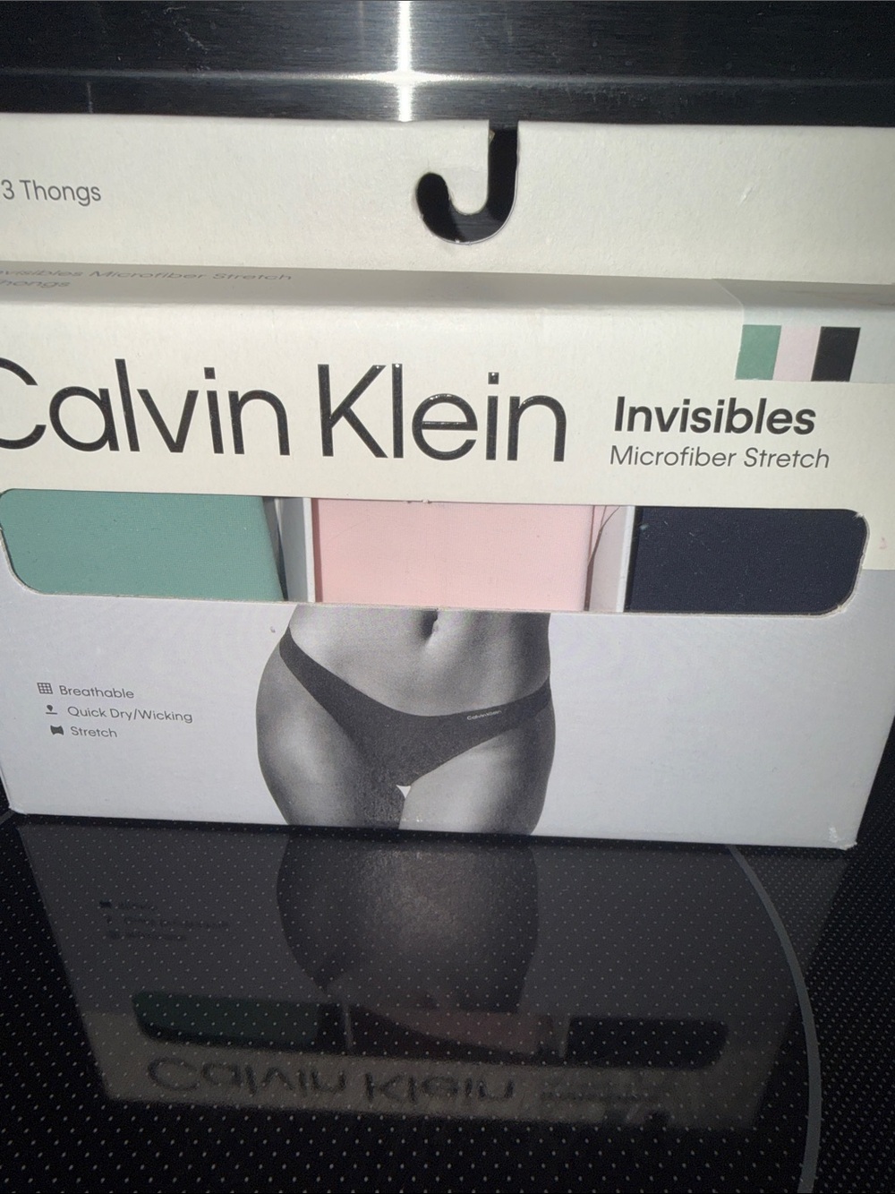 Calvin Klein Three-Pack Invisibles Thongs - Mint, Pink, Black